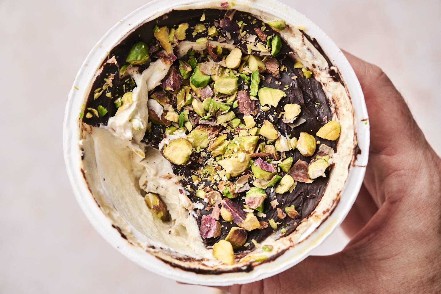 A single finished Dubai chocolate yogurt cup on a plate.