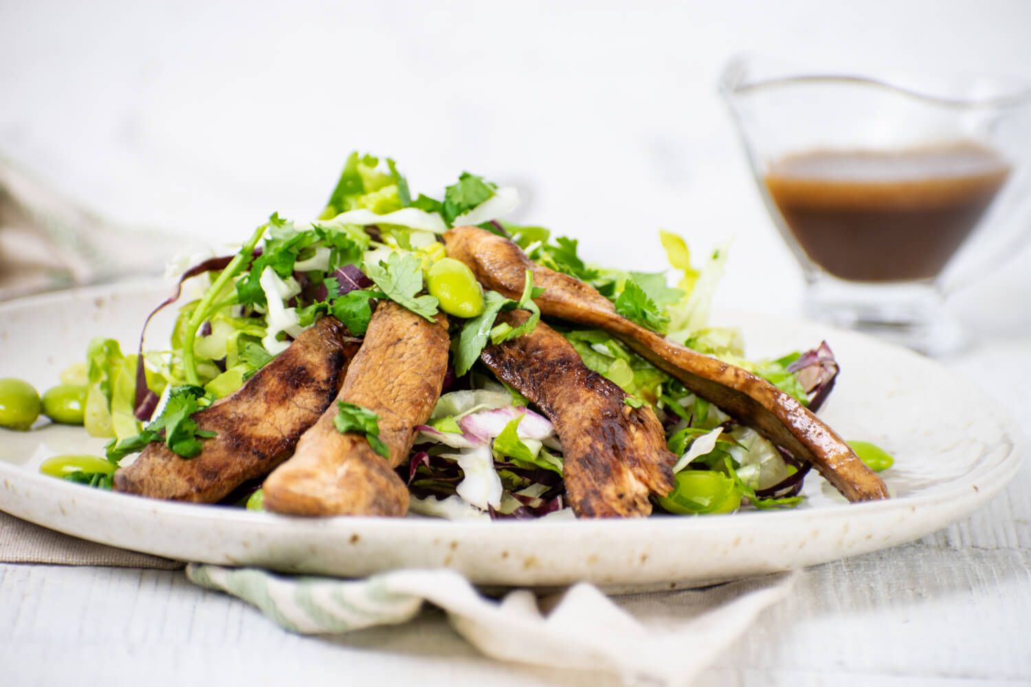 Healthy Chinese Chicken Salad with chicken breast, edamame, and cabbage with sesame dressing.