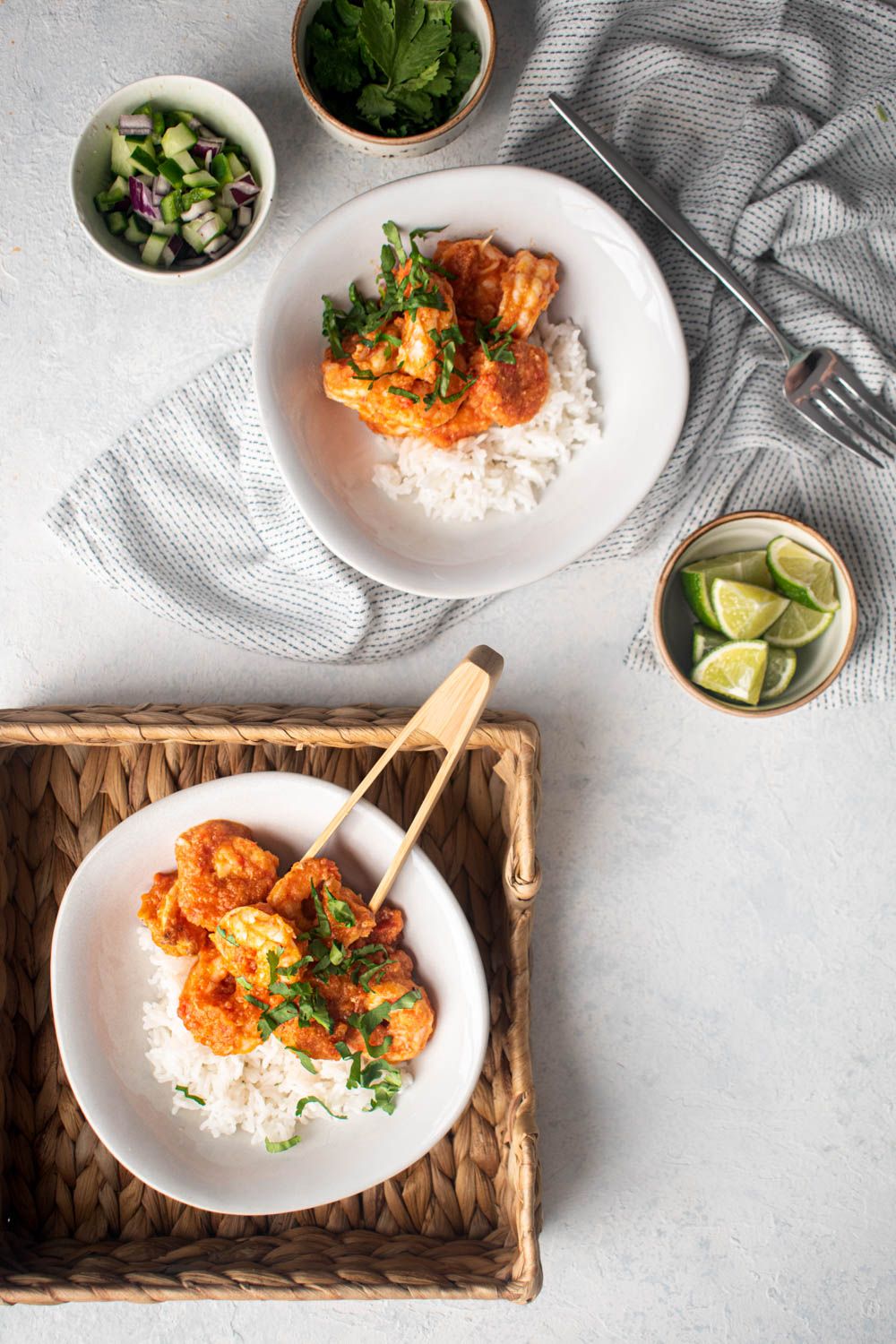 Mexican Camarones a la diabla in a spicy red sauce with rice, cilantro, and limes. 