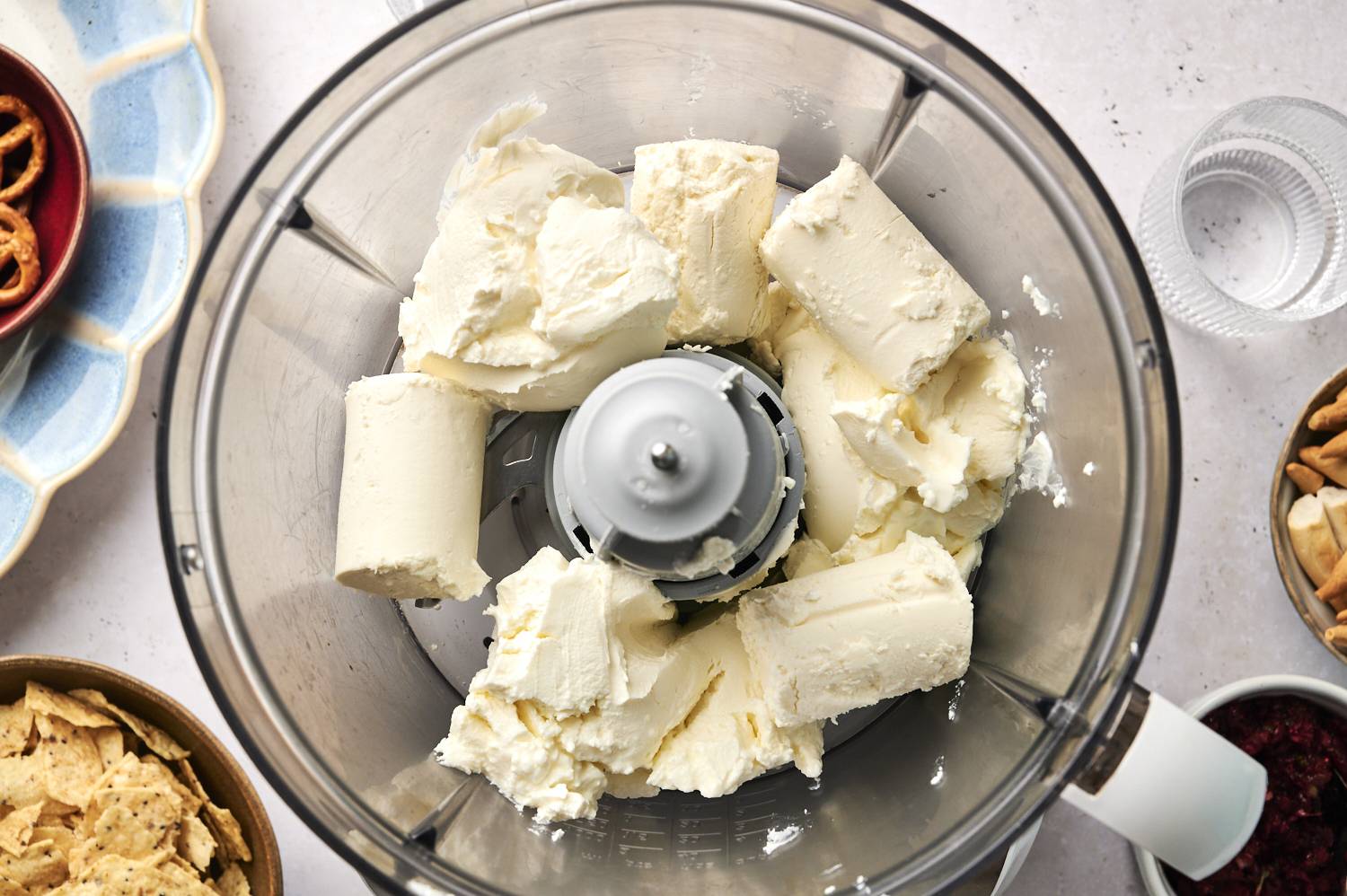 Cream cheese and goat cheese in a food processor.
