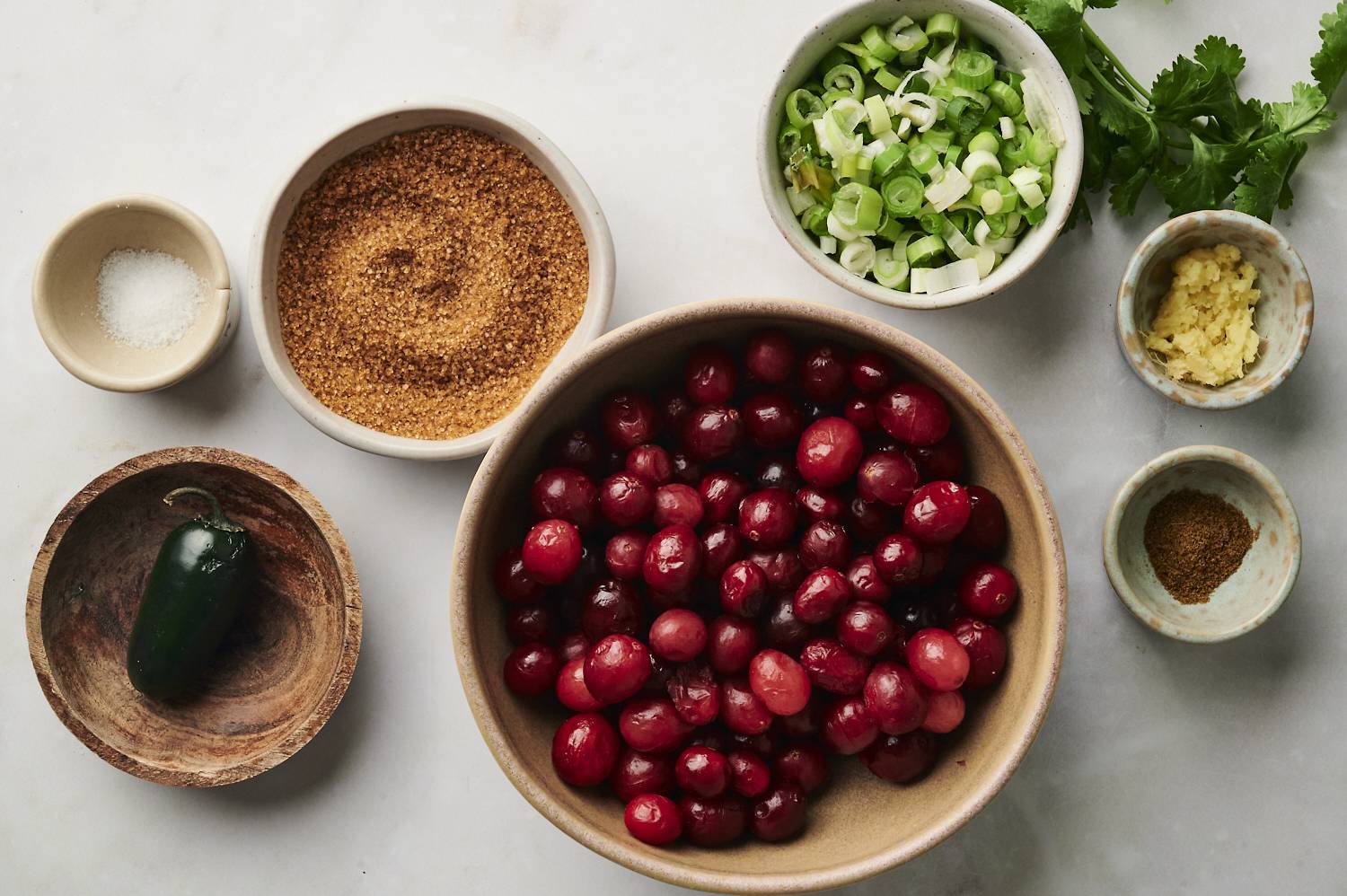 Ingredients to make cranberry relish sitting on a counter.