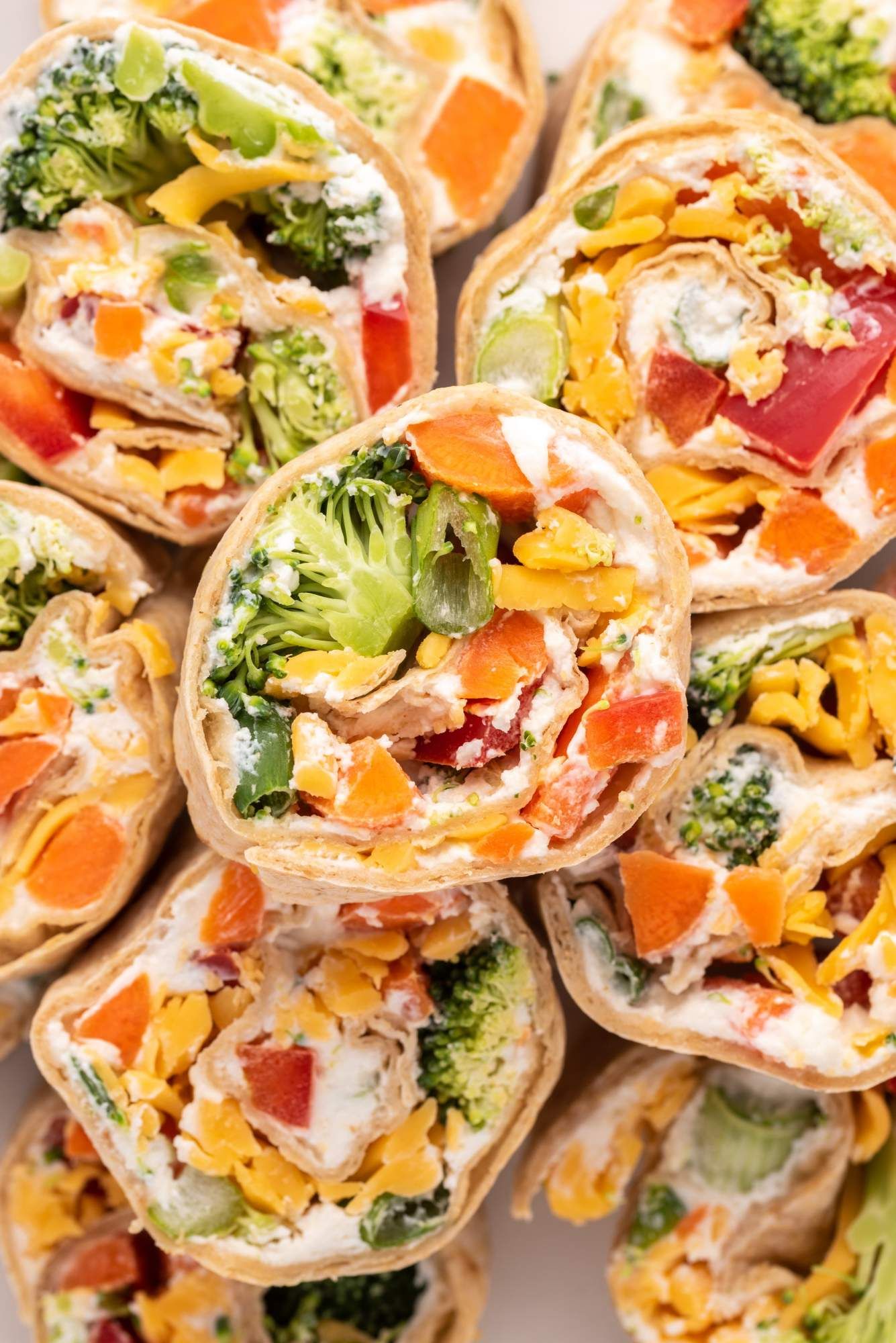 Vegetable pinwheels with cream cheese, bell peppers, broccoli, and carrots wrapped in a whole wheat tortilla.