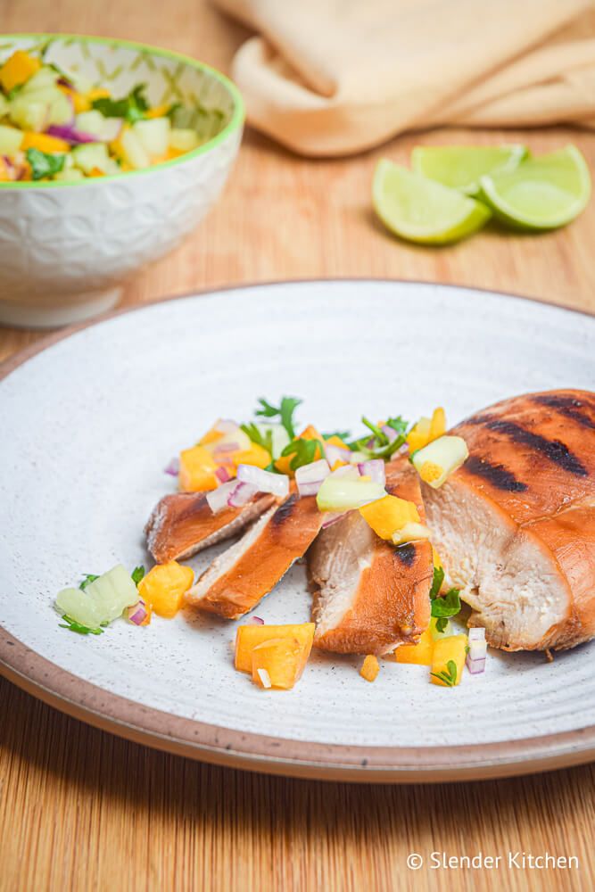 Grilled chicken topped with peach salsa with diced cucumbers, cilantro, and red onions.