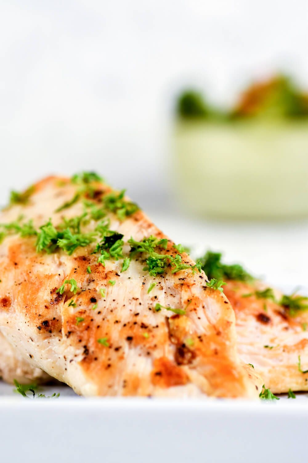 Chicken breast covered in an herb rub and seared in a pan.