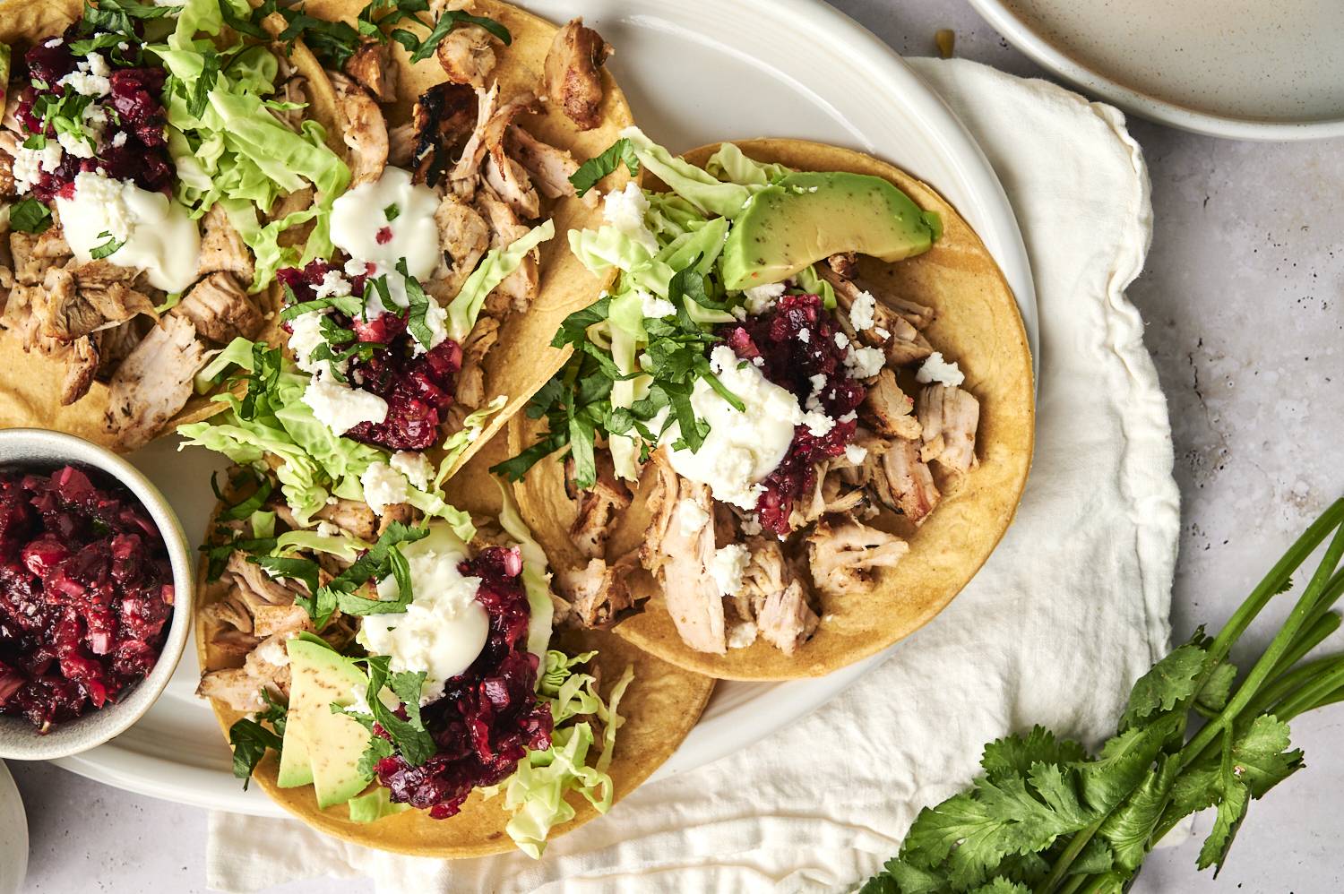 Shredded leftover turkey tacos with all toppings being served.