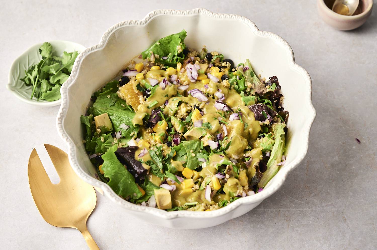 A fresh and vibrant Mexican quinoa salad with black beans, corn, avocado, and a creamy cilantro dressing.