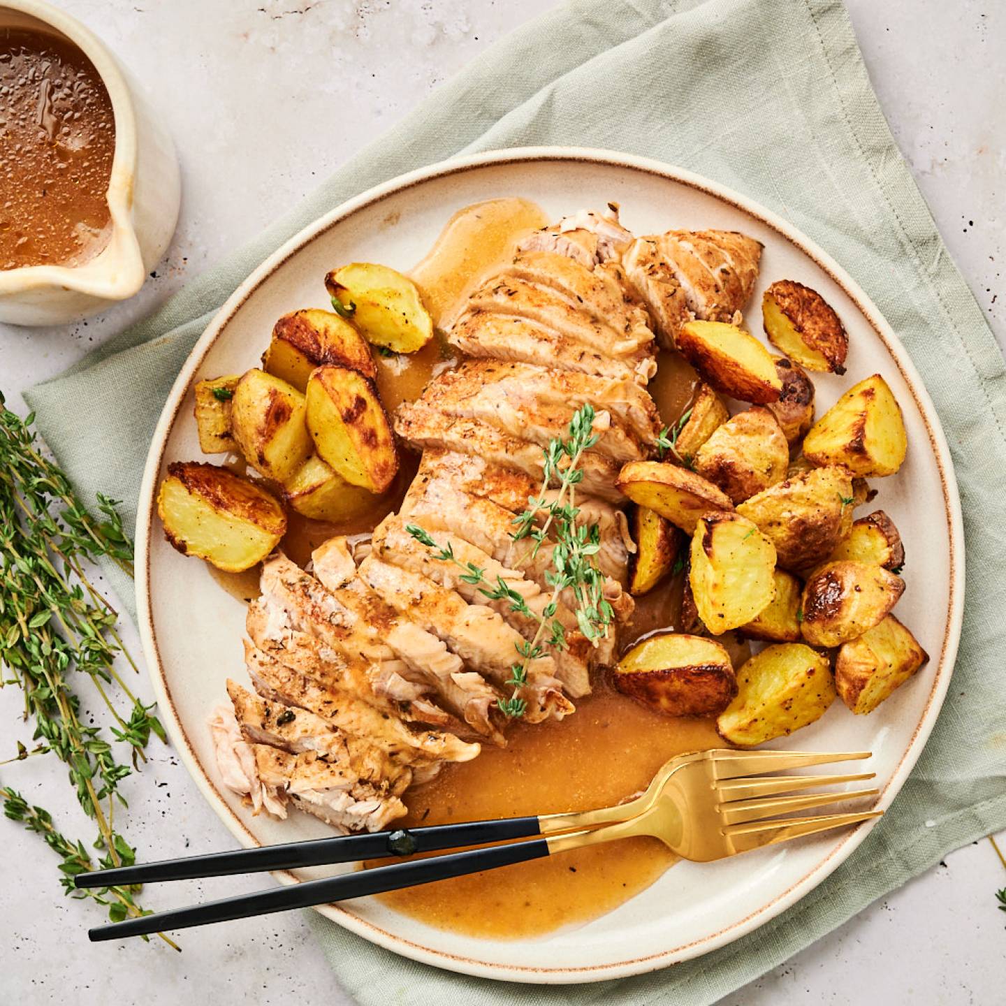 Instant Pot turkey tenderloin with roasted potatoes and fresh thyme.