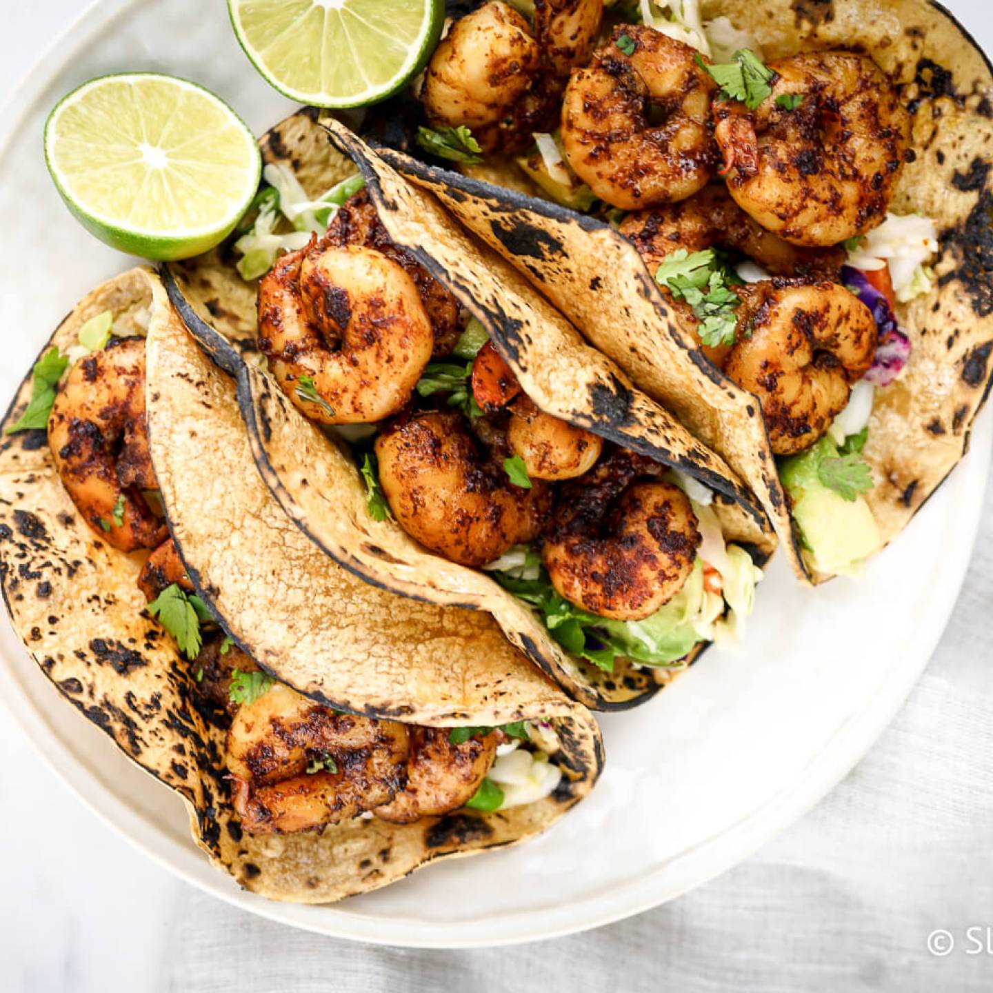 Low carb shrimp tacos with cabbage slaw and avocado.