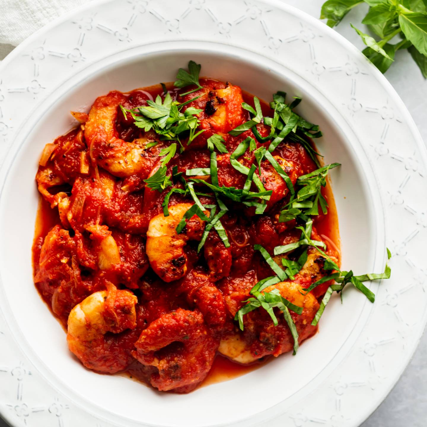 Shrimp fra diavolo with cooked shrimp in spicy tomato sauce with fresh basil.