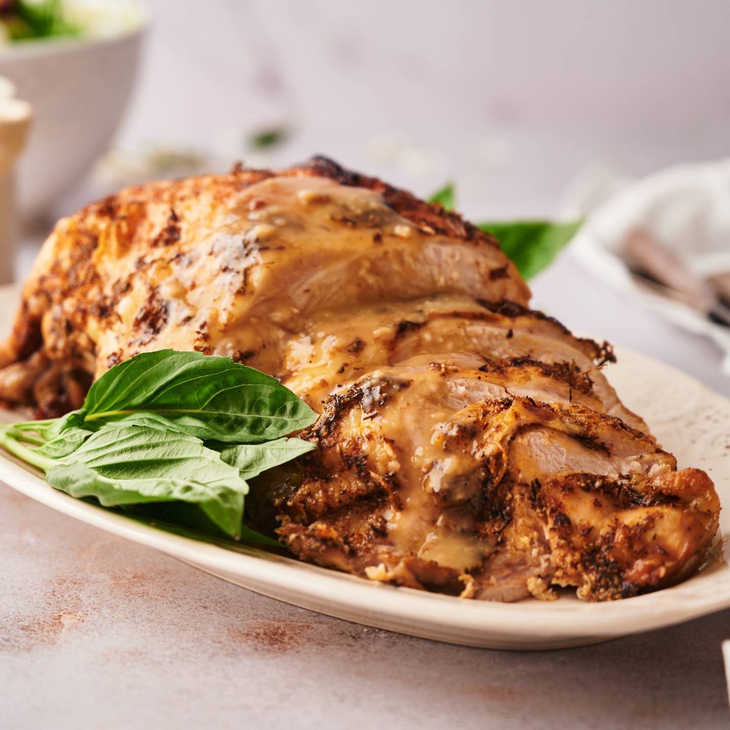 Crockpot boneless turkey breast sliced on a plate with homemade gravy.
