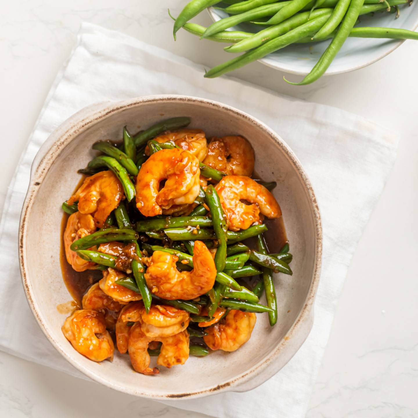 Teriyaki shrimp with green beans in a bowl with homemade teriyaki sauce.