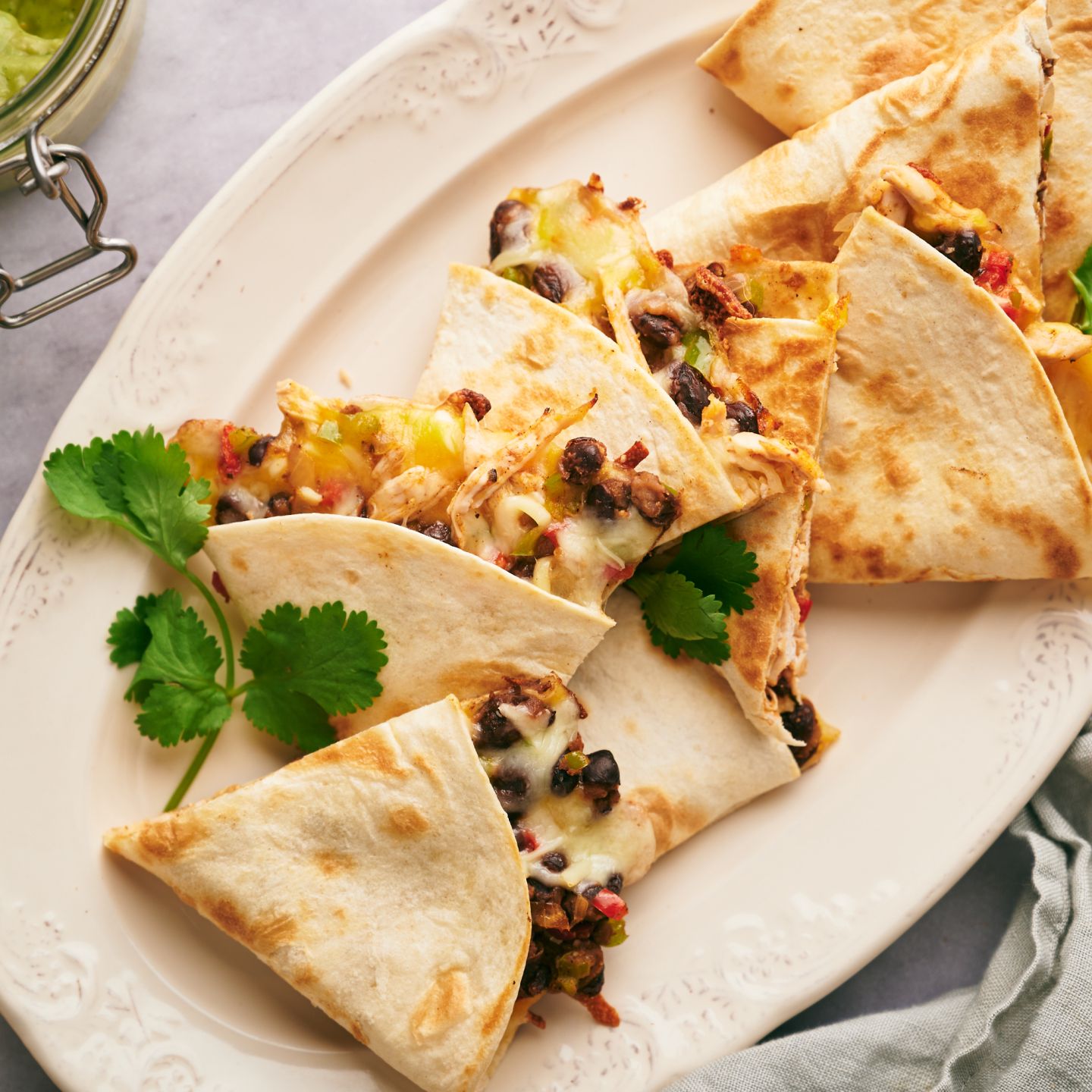 Turkey quesadillas with shredded turkey, black beans, peppers, and cheese cooked in flour tortillas with cilantro and salsa.