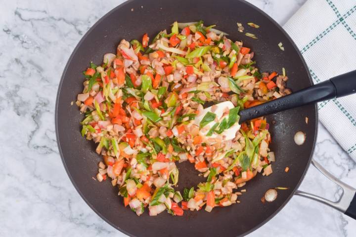 Veggies for chicken lettuce wrap filling cooking in a pan.