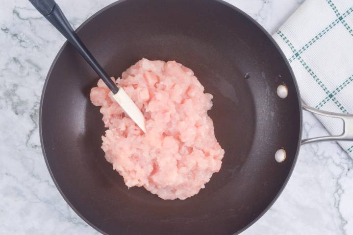 Ground chicken for lettuce wraps in a skillet.