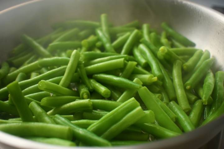 Green beans cooking in a skillet.