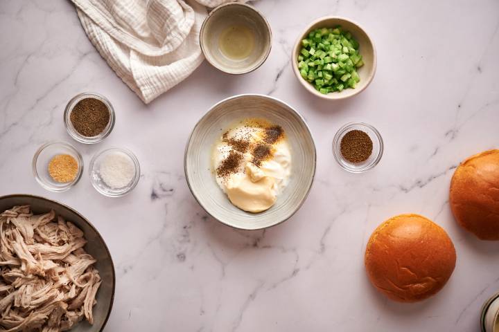 Mayonnaise, yogurt, mustard, and spices in a bowl.