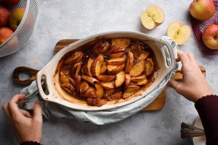 Tender baked apples with caramelized edges in a baking dish.