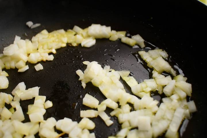Onions cooking in a skillet.