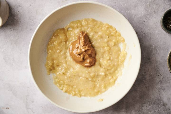 A top-down shot of a jar with oats, chia seeds, and banana slices.
