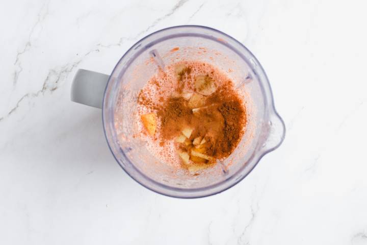  Carrots, mango, banana, ginger, and cinnamon in a blender.