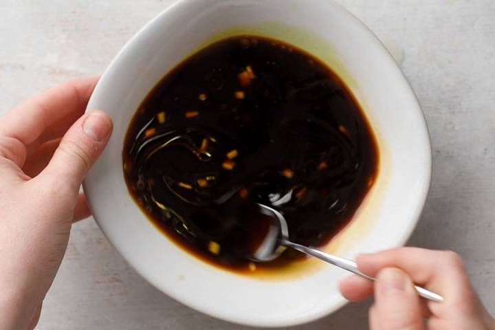 Sesame sauce being stirred in a small bowl.