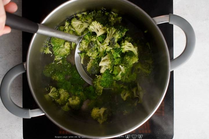 Broccoli being boiled until bright green and tender crisp.
