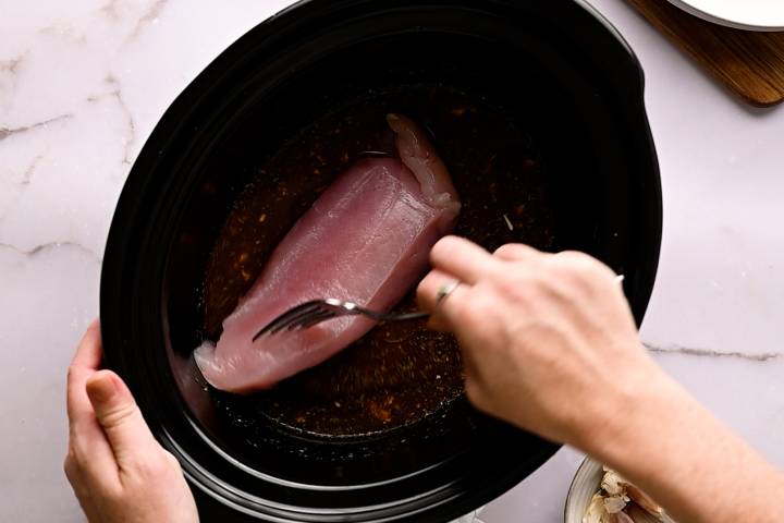 Slow cooker with turkey breast tenderloins.