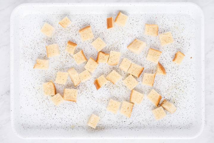 Sour dough bread cut into small pieces tossed with olive oil to make croutons.