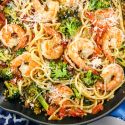 Shrimp and broccol pasta with lemon and garlic in a skillet.