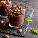 Chocolate chia seed pudding in a glass with a sprig of mint.