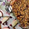Cranberry apple crisp with a oatmeal crumble topping in a baking dish. 