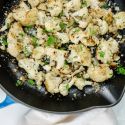 Garlic Parmesan Roasted Cauliflower in a skillet with fresh parsley.