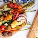 Grilled vegetables including carrots, zucchini, asparagus, corn, tomatoes, mushrooms, peppers, and red onion.