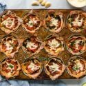 Lasagna cupcakes with ricotta cheese, vegetables, and mozzarella cheese baked in a muffin tin with marinara sauce.