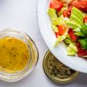 Light Italian dressing in a jar with olive oil, vinegar, and lemon and served over a green salad.
