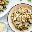 Mushroom pasta with a creamy sauce in a bowl with a spoon.