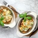 Spaghetti squash lasagna boats in two casserole dishes with basil.