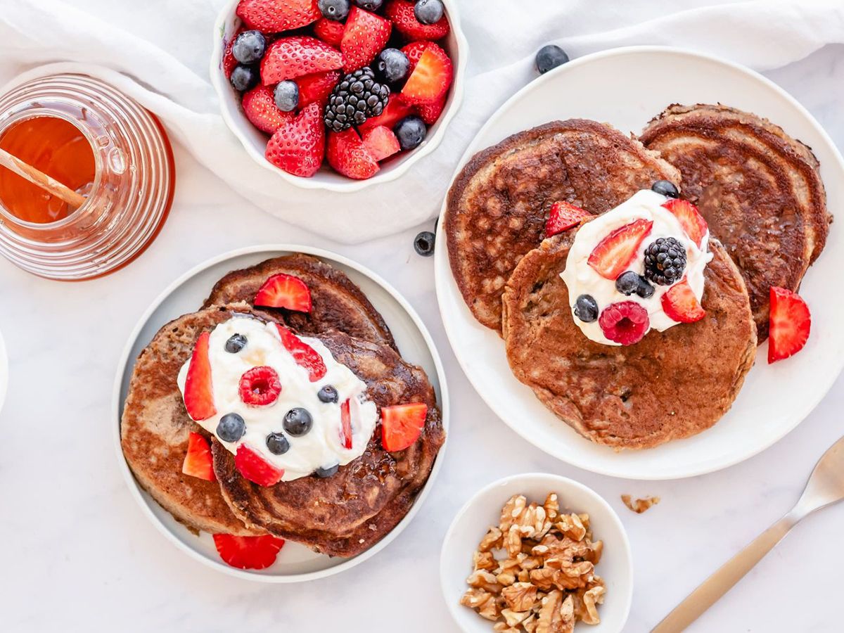 Dairy Free Almond FLour Pancakes on a plate with honey and walnuts