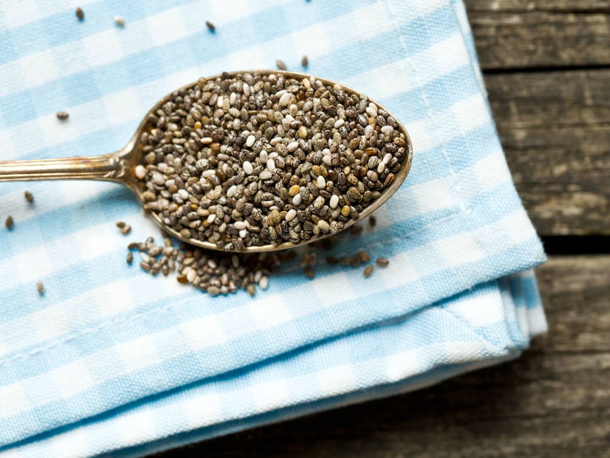 Chia seeds on a spoon on a table