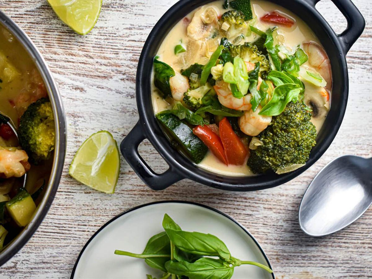 Coconut Curry Shrimp in a Bowl with Basil and Lime for Garnishing